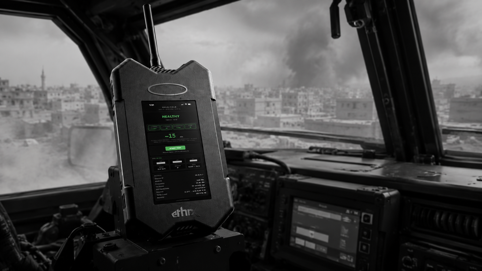 HALO node mounted in a vehicle cab, mesh status healthy, degraded city visible beyond the windshield